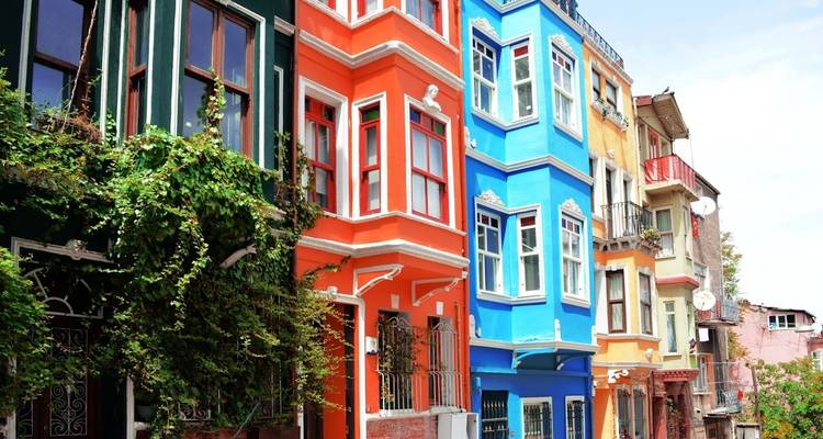 Colorful row of houses with vibrant paint and blue skies.