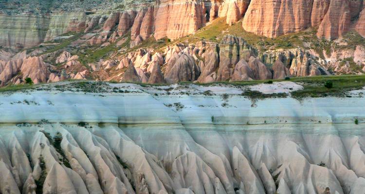 View of colorful rock formations and steep cliffs.