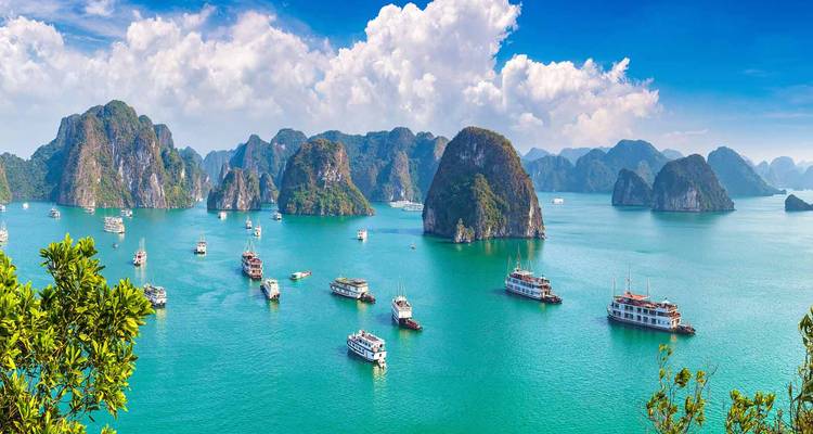 Halong Bay with boats scattered among limestone islands.