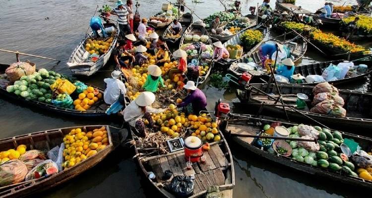 Crowded floating market with people on boats.