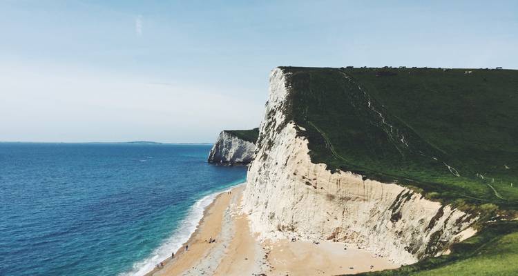 Dramatic coastal cliffs with a beach.