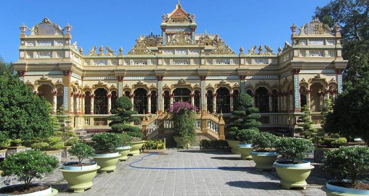 Ornamentaler Garten vor einem dekorativen Gebäude.