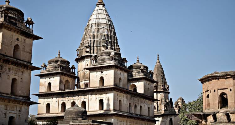 Sunlit historic buildings with ornate towers.