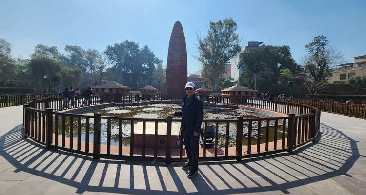 Persoon die voor een monument in een tuin staat.