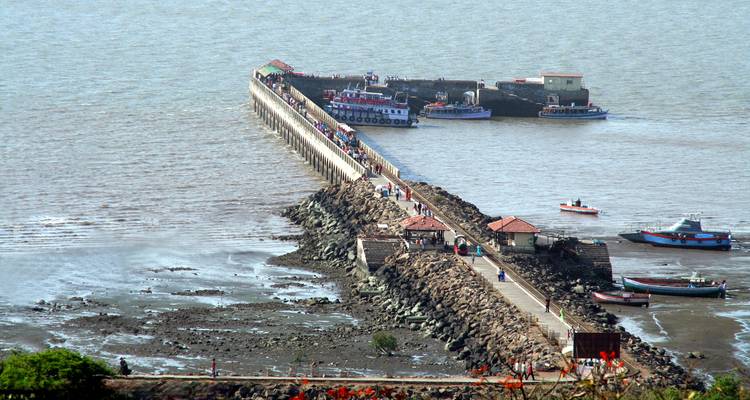 Top view of a pier with boats docked around.