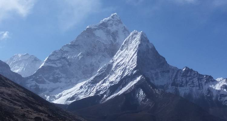 Snowy peaks of mountain under a blue sky.