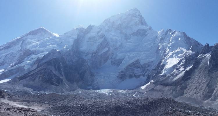 Snow-covered rugged mountains under a clear sky.
