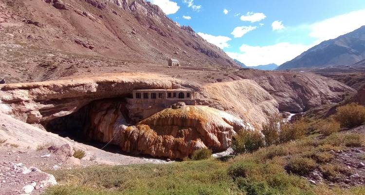 Rock formation with a historical site built into a natural bridge.