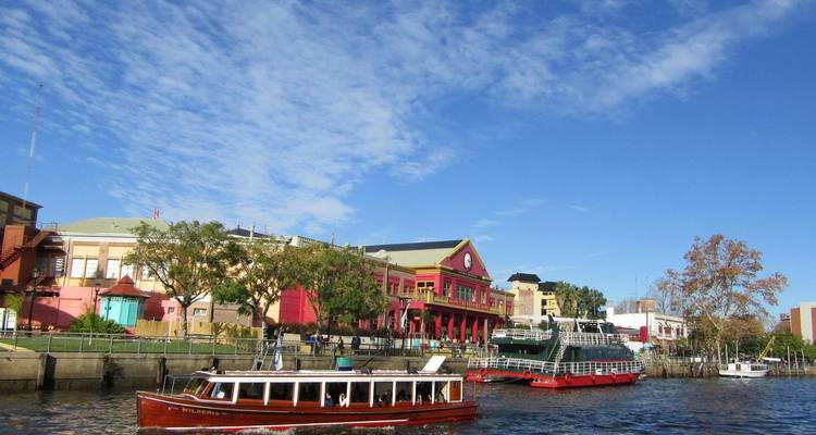 Colorful riverside buildings with boats on the water.