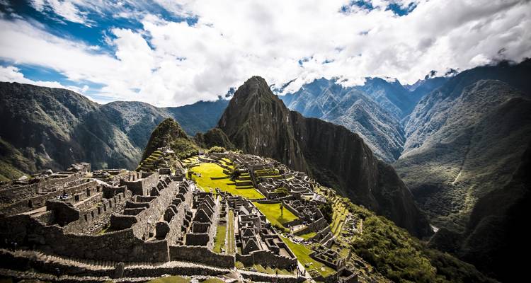 View of Machu Picchu ruins with a mountain backdrop.