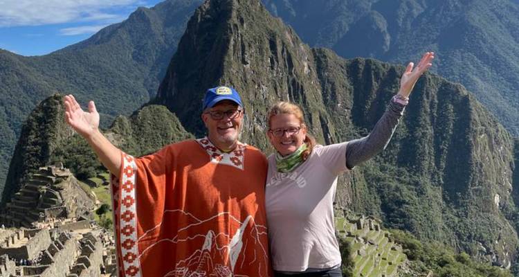 Two people celebrating in front of Machu Picchu.