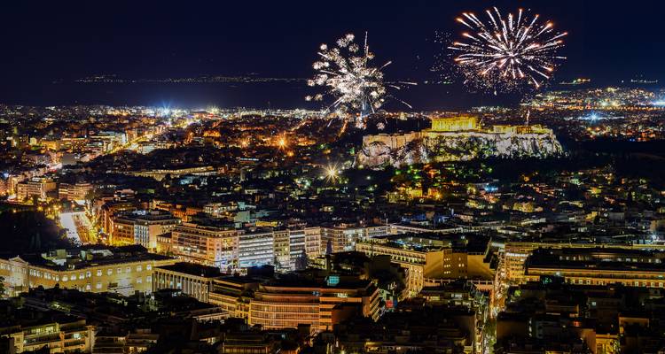 Cityscape view of Athens with fireworks over the Acropolis.
