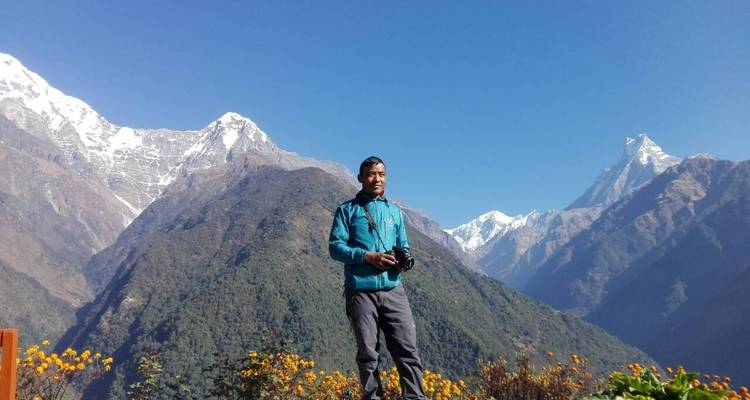 Person standing in front of the Annapurna range.