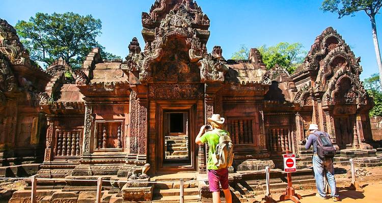 Tourists taking photos at Banteay Srei temple.