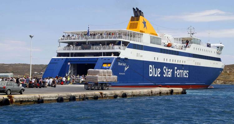 Car ferry with passengers boarding at a dock.