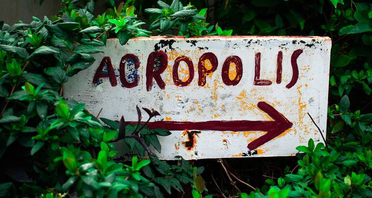 Creative handmade sign pointing towards Acropolis.