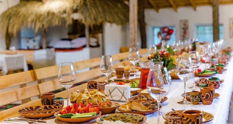 Mesa puesta con comida moldava en un ambiente tradicional.