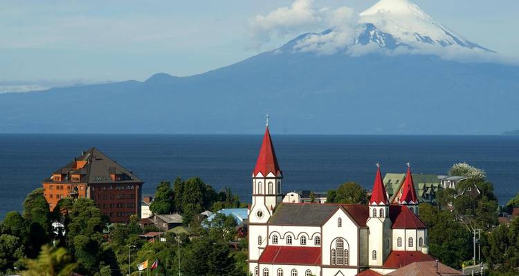 Scenic view of a church with a mountain backdrop.