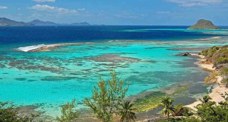 Turquoise water and sandy beach with distant islands