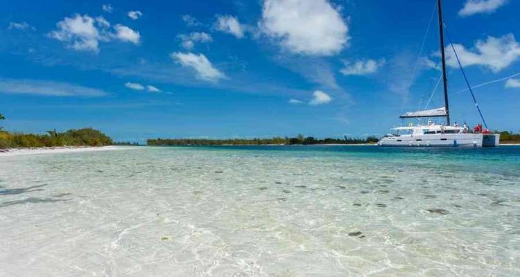 Clear shallow waters with a sailing boat