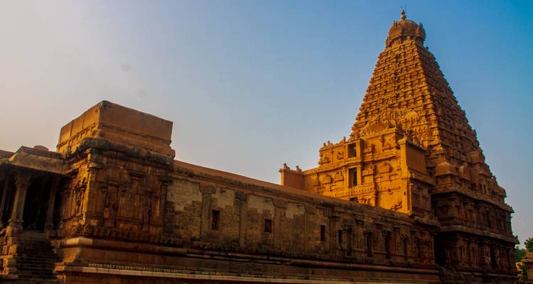 Ein historischer Tempel mit Schnitzereien, in warmes Sonnenlicht getaucht.