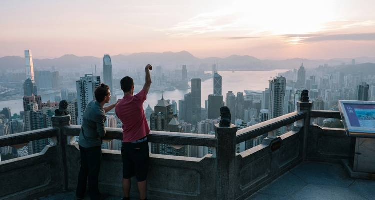 Viendo un horizonte urbano al atardecer con dos personas.