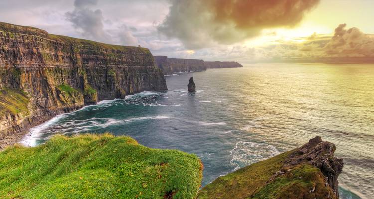 Dramatic sunset over the towering sea cliffs and Atlantic Ocean at the Cliffs of Moher