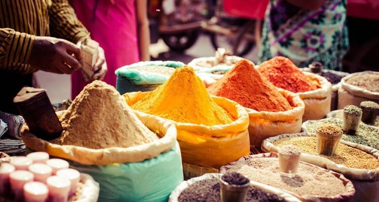 Colorful spices on display in a vibrant market.