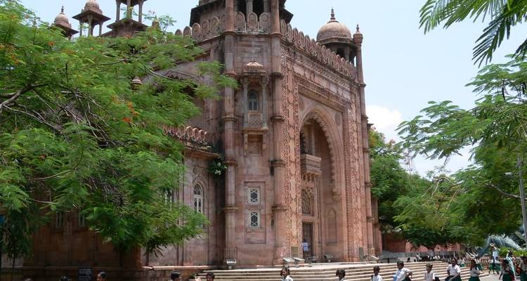 An ornate historic building with children playing in front.