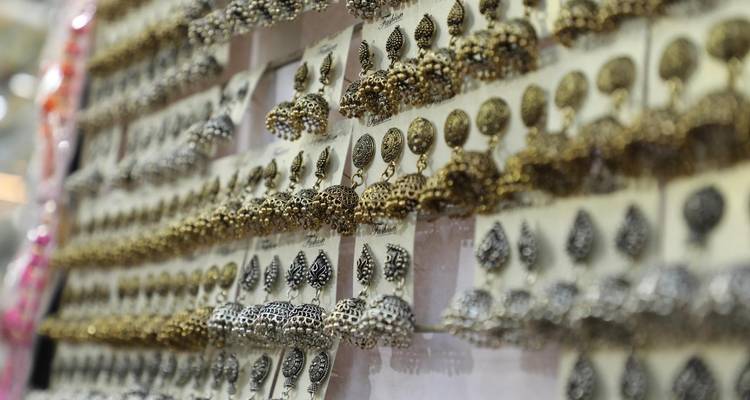 A display of intricate earrings in a market setting.