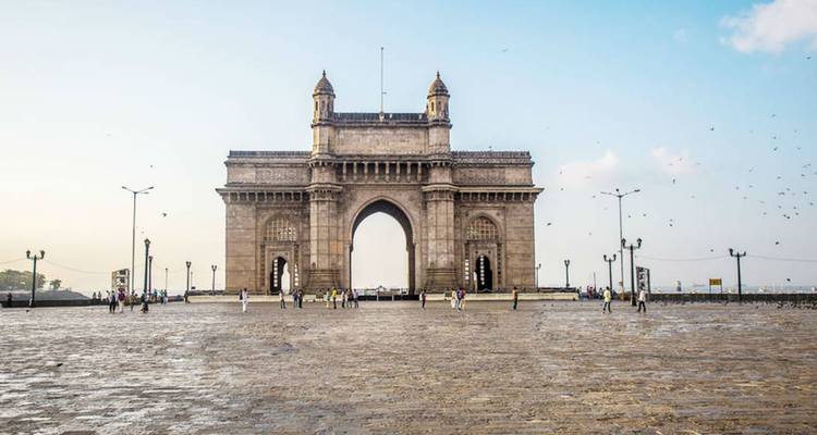 The Gateway of India with people around.