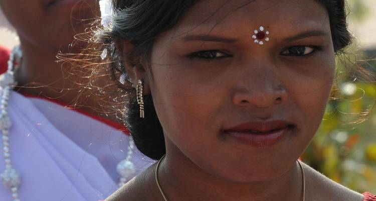 Close-up of a woman adorned with traditional Indian jewelry.