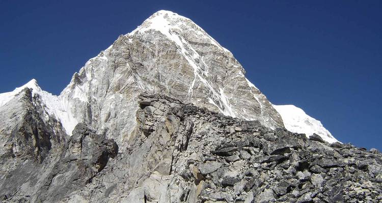 Mountain peak with clear blue sky.