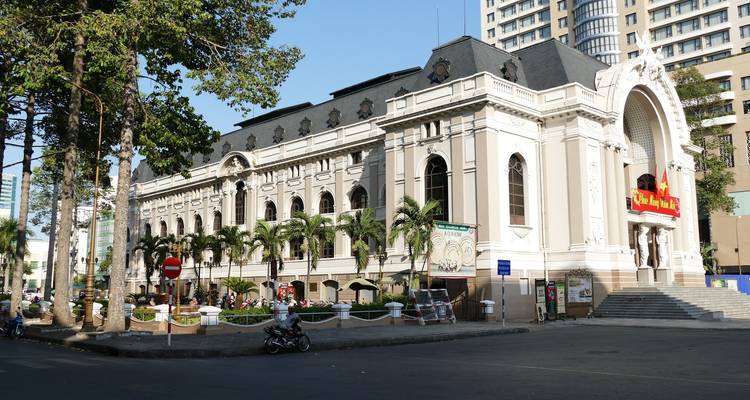 Edificio de estilo arquitectónico colonial francés con palmeras en la Ciudad de Ho Chi Minh.