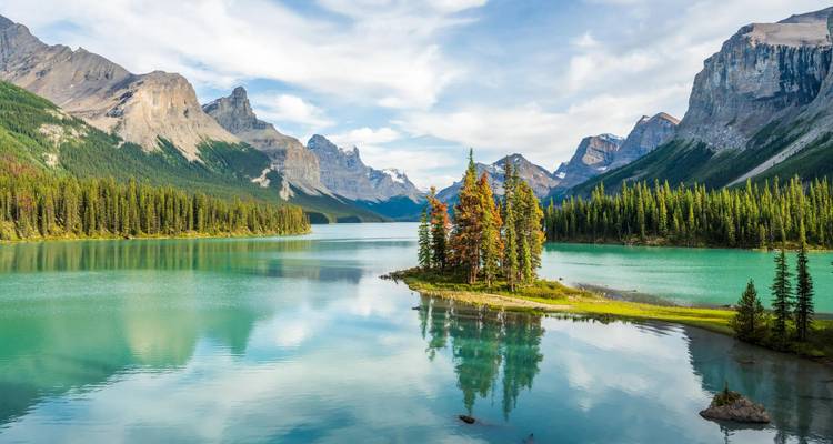 Turquoise waters of Maligne Lake surround tiny Spirit Island backed by dramatic Rocky Mountain peaks.