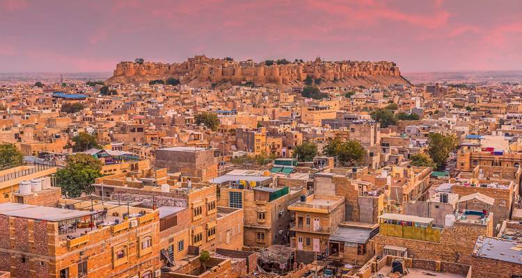 Ciel au coucher de soleil rose surplombant la vaste cité de grès doré et le fort de Jaisalmer.