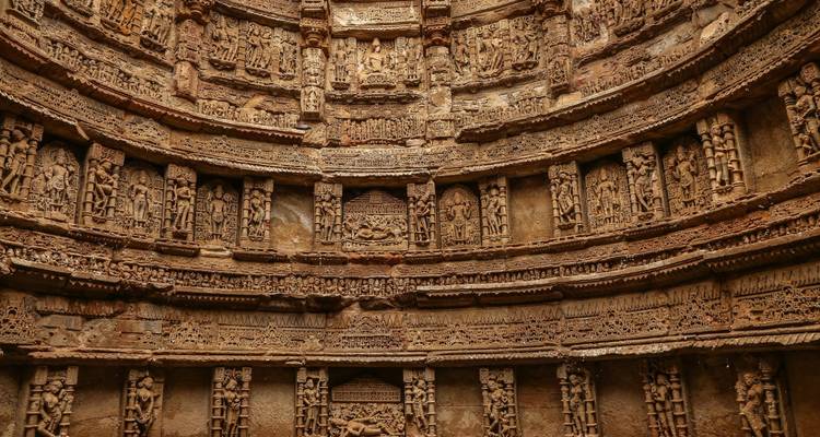 Intricately carved stone wall showing historical scenes.