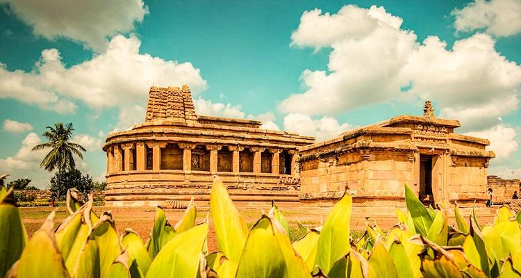Historic temple with bright sky and lush surroundings.