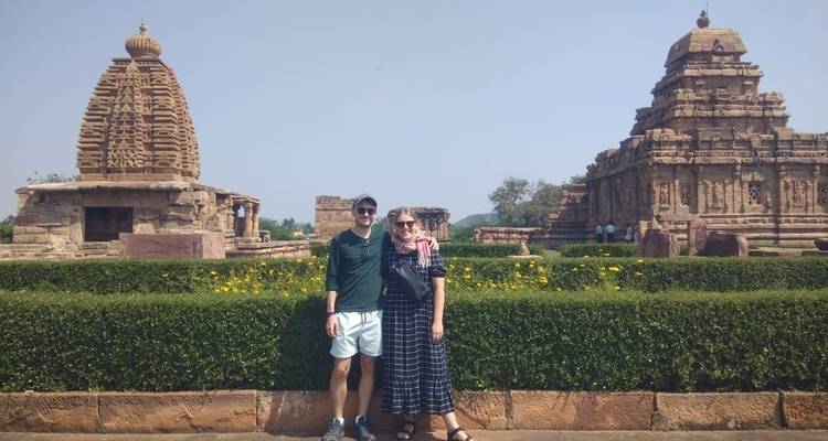 Two people posing with temples in the background.