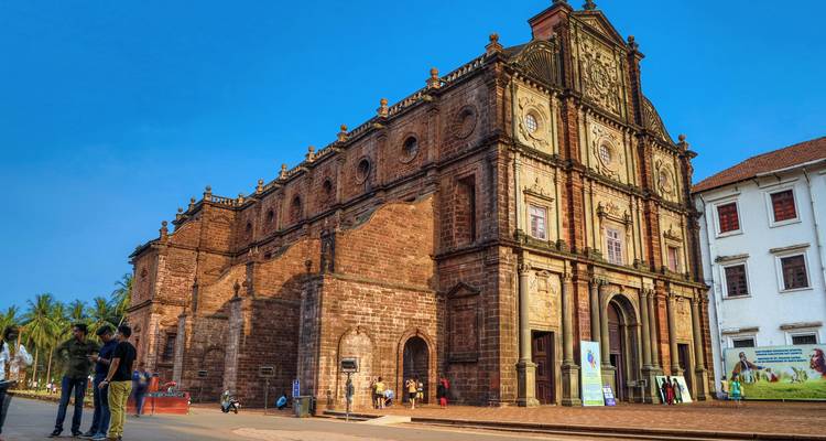 Historical church facade with people near entrance.