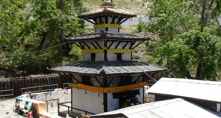 Pagoda-style temple in a hilly forest area.