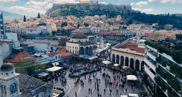 Bustling Monastiraki Square with Acropolis hill towering above Athens cityscape
