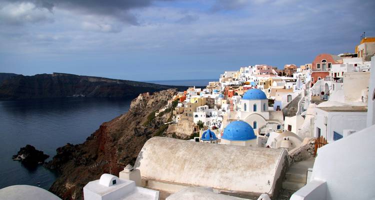 Overcast morning view of Santorini caldera with iconic blue domes and cliffside dwellings