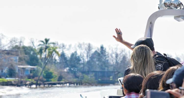 People on a boat enjoying a waterway.