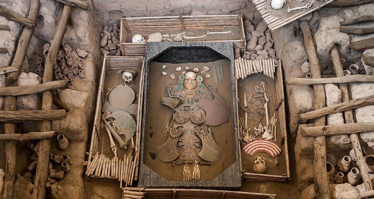 Archaeological site with ancient artifacts and remains, possibly representing a royal burial.