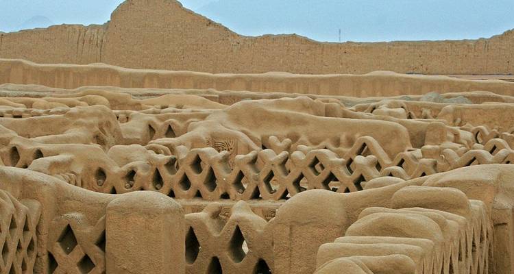 Expansive view of an ancient adobe city with extensive walls.