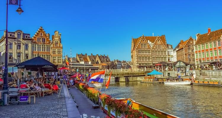 Colorful riverside cafes in a historic European city.
