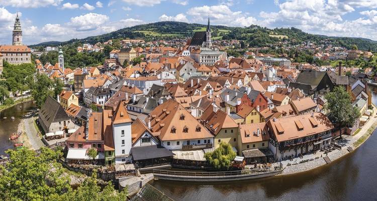 Charming town with red-tiled roofs by a river.