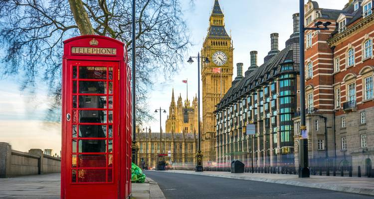 Iconic clock tower with traditional red telephone booth in foreground.