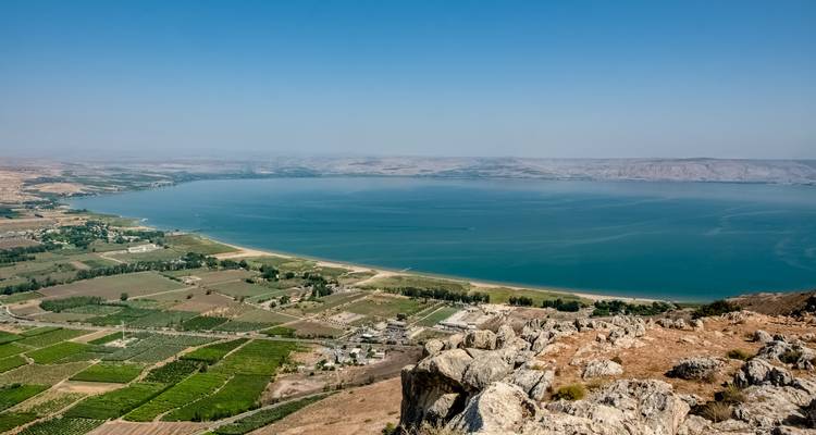Expansive view of a lake surrounded by hills.